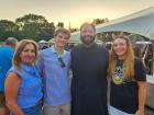 Church leader with guests at the St. Nectarios Greek Fest in Palatine