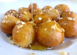 Greek Loukoumades, made of deep fried dough coated in honey syrup and cinnamon