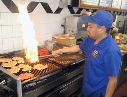 Cooking great chicken sandwiches at Charcoal Delights in Des Plaines