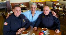 Police officers with owner at Tasty Waffle Restaurant in Romeoville