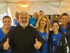 Church leader with volunteers - St. Demetrios Greek Fest, Elmhurst