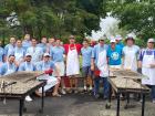 Hard working volunteers with church leader at St. Nectarios Greek Fest in Palatine