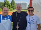 Church leader with festival staff - St. Sophia Greekfest, Elgin