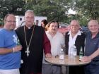 Church leader with volunteer and guests - St. Sophia Greekfest, Elgin