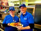 Friendly staff with food at Goodi's Restaurant in Niles
