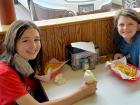 Sisters enjoying fries and ice cream at Nick's Drive In Restaurant Chicago