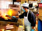 Cooking the famous burgers at Nick's Drive In Restaurant Chicago