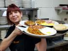 Friendly server with breakfast at Tasty Waffle Restaurant in Plainfield