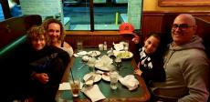 Family enjoying dinner at Andrew's Open Pit & Spirits in Park Ridge
