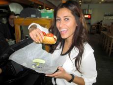 Loyal customer enjoying hot dog at Backyard Grill in Chicago