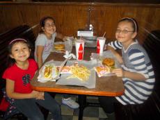 Girls enjoying burgers and hotdogs at Billy Boy's Restaurant in Chicago Ridge