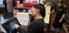 Friendly staff taking carry-out order at Brandy's Gyros in Chicago