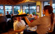 Serving the flaming Saganaki at Brousko Authentic Greek Cuisine Schaumburg