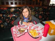 Young customer enjoying the gyros at Burger Baron Restaurant in Arlington Heights