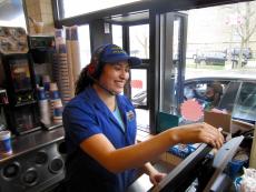 Friendly drive-thru worker at Charcoal Delights Restaurant in Chicago
