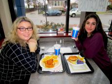 Friends enjoying lunch at Charcoal Delights Restaurant in Chicago