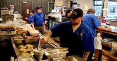 Busy kitchen crew at Charcoal Delights Restaurant in Chicago