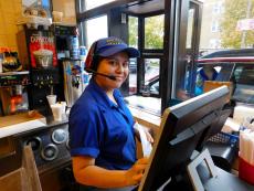 Friendly drive-thru worker at Charcoal Delights Restaurant in Chicago