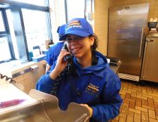 Friendly drive-thru worker at Charcoal Delights Restaurant in Chicago