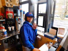 Friendly drive-thru worker at Charcoal Delights Restaurant in Chicago