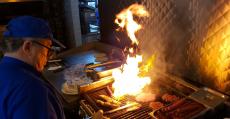 Hard working grill man at Charcoal Delights Restaurant in Chicago