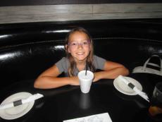 Young customer enjoying lunch with her family at Draft Picks Sports Bar in Naperville