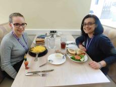 Customers enjoying skillet and sandwich at Eggs Inc Chicago