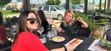 Friends enjoying outdoor dining at Ellwood Steak & Fish House in DeKalb