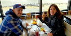 Family enjoying tacos and hot dogs at Franksville Restaurant in Chicago