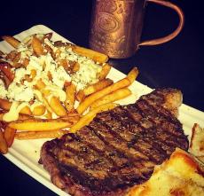 Greek style rib-eye and fries at Jimmy D's District Restaurant in Arlington Heights