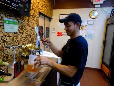 Friendly staff serving beer at Kosta's Gyros in Algonquin