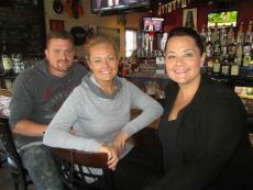 Friends enjoying drinks at Manny's Ale House in Elmhurst