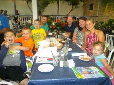 Family enjoying dinner on the patio at Mykonos Greek Restaurant in Niles
