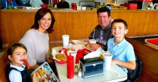 Family enjoying lunch at Nick's Drive In Restaurant in Chicago