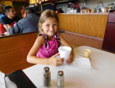 Young customer enjoying ice cream with her Mom at Nick's Drive In Chicago