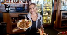 Friendly server with gyros at Niko's Tavern in Elgin