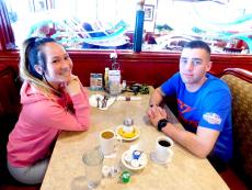 Young couple enjoying breakfast at Omega Restaurant & Pancake House in Downers Grove