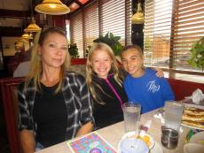 Family enjoying breakfast at Omega Restaurant & Pancake House in Downers Grove