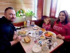 Family enjoying breakfast at Omega Restaurant & Pancake House in Downers Grove