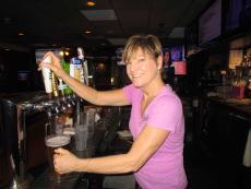 Friendly bar server at Sports Page Bar & Grill in Arlington Heights